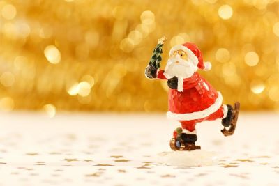 Santa skating with a gold background
